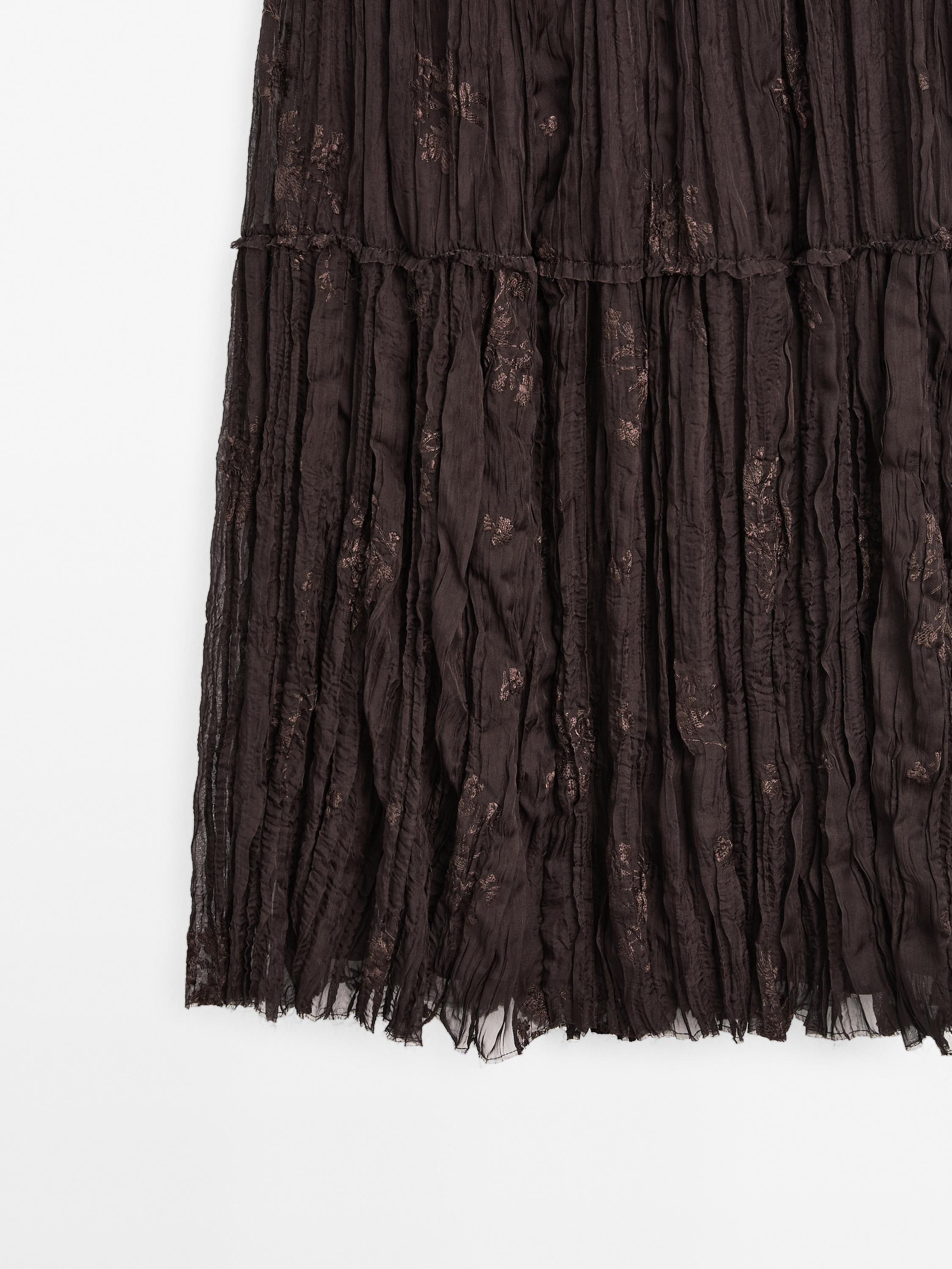 Long pleated skirt with embroidered detail